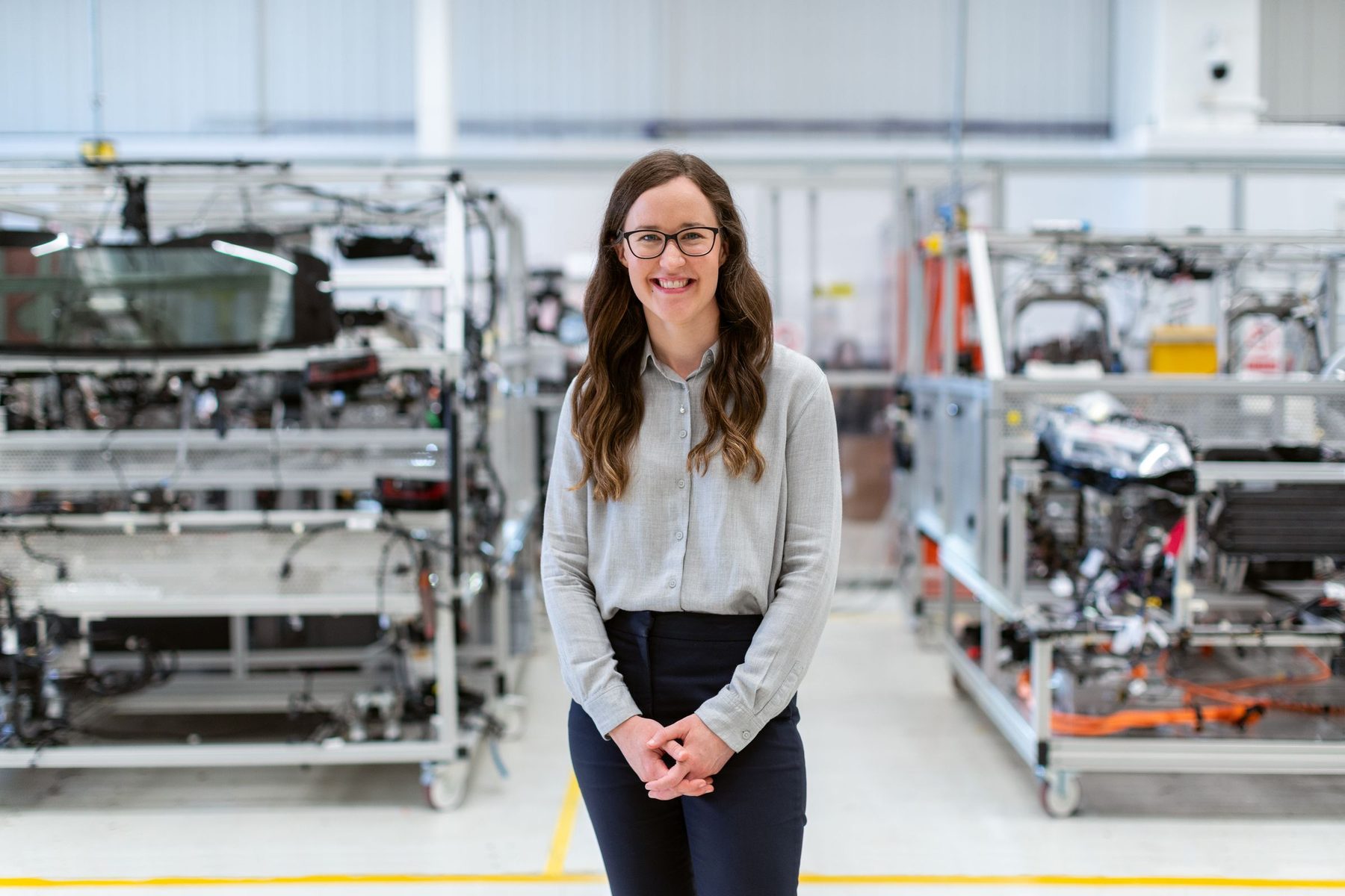 The owner of a manufacturing business standing on her production floor